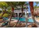 Stunning backyard pool with lush tropical landscaping and a spacious veranda for outdoor living at 3308 Oleander Dr, Hernando Beach, FL 34607