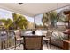 Small screened balcony with table and chairs at 3308 Oleander Dr, Hernando Beach, FL 34607