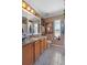 Bathroom with granite countertop, wood cabinets and shower at 3497 Chadwick Ave, Spring Hill, FL 34609