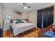 King-size bed, hardwood floors, and large window at 3497 Chadwick Ave, Spring Hill, FL 34609