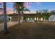 House exterior at dusk with palm trees and yard at 3497 Chadwick Ave, Spring Hill, FL 34609