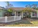 House entrance with white picket fence and pink shutters at 3497 Chadwick Ave, Spring Hill, FL 34609