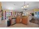 Kitchen features an island with seating and a view into the living room at 3497 Chadwick Ave, Spring Hill, FL 34609