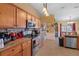 Kitchen boasts stainless steel appliances and ample wood cabinetry at 3497 Chadwick Ave, Spring Hill, FL 34609