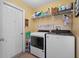 Laundry room with washer, dryer, and shelving at 3497 Chadwick Ave, Spring Hill, FL 34609
