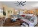Open concept living room with a cozy sectional sofa and kitchen views at 3497 Chadwick Ave, Spring Hill, FL 34609