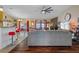 Open concept living area with sectional sofa and kitchen island at 3497 Chadwick Ave, Spring Hill, FL 34609
