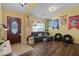 Living room with sectional sofa, dark wood floors, and a projection screen at 3497 Chadwick Ave, Spring Hill, FL 34609