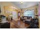 Bright living room with hardwood floors and a comfy sectional sofa at 3497 Chadwick Ave, Spring Hill, FL 34609