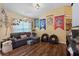 Spacious living room featuring a large sectional sofa and hardwood floors at 3497 Chadwick Ave, Spring Hill, FL 34609
