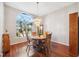 Round dining table with four chairs, hardwood floors at 3912 Rudder Way, New Port Richey, FL 34652