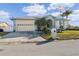 Single-story house with a large driveway and mature trees at 3912 Rudder Way, New Port Richey, FL 34652