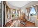 Sunlit sitting area with hardwood floors and rocking chair at 3912 Rudder Way, New Port Richey, FL 34652