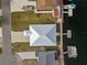 Aerial view of a waterfront home with a metal roof and docks on a canal at 4045 Centavo Ct, Hernando Beach, FL 34607