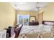 Bright bedroom with a view through large windows and comfortable furnishings at 4045 Centavo Ct, Hernando Beach, FL 34607