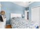 Bright bedroom featuring blue walls, ceiling fan and access to ensuite bathroom at 4045 Centavo Ct, Hernando Beach, FL 34607