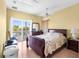 Well-lit bedroom with a large bed, dresser, and balcony access offering scenic views at 4045 Centavo Ct, Hernando Beach, FL 34607