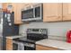Modern kitchen with stainless steel appliances, granite countertops, and wooden cabinets at 4045 Centavo Ct, Hernando Beach, FL 34607
