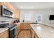 Spacious kitchen featuring granite countertops, modern appliances, and plenty of cabinet storage at 4045 Centavo Ct, Hernando Beach, FL 34607