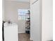 Functional laundry room with a washing machine, storage rack, and window providing natural light at 4045 Centavo Ct, Hernando Beach, FL 34607
