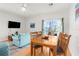 Inviting living room with a dining table, comfortable sofa, and large windows that offer scenic views at 4045 Centavo Ct, Hernando Beach, FL 34607
