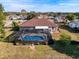 Aerial view showing home, pool, and backyard at 4061 Montano Ave, Spring Hill, FL 34609