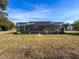 Large backyard with screened pool enclosure at 4061 Montano Ave, Spring Hill, FL 34609