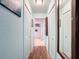 Clean hallway with light walls and wood flooring at 4061 Montano Ave, Spring Hill, FL 34609