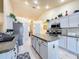 Modern kitchen with stainless steel appliances and an island at 4061 Montano Ave, Spring Hill, FL 34609
