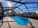 Large kidney shaped pool with screened enclosure and patio at 4061 Montano Ave, Spring Hill, FL 34609