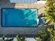 An aerial view of refreshing blue pool with surrounding patio at 4292 Maple Ne St, St Petersburg, FL 33703