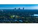 Aerial view of a neighborhood near a city skyline, showing lush green landscape and waterways at 4292 Maple Ne St, St Petersburg, FL 33703