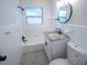 Clean bathroom with a tub, granite countertop and new fixtures at 4292 Maple Ne St, St Petersburg, FL 33703