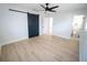 Simple bedroom featuring light walls, ceiling fan and new flooring at 4292 Maple Ne St, St Petersburg, FL 33703
