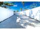 Long concrete driveway with white fence on either side at 4292 Maple Ne St, St Petersburg, FL 33703
