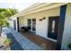Modern front porch with a comfortable bench and tile flooring at 4292 Maple Ne St, St Petersburg, FL 33703