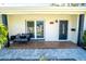 Inviting front porch with wood-like tile floor and modern entryway at 4292 Maple Ne St, St Petersburg, FL 33703