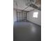 Spacious garage with painted floor and overhead storage at 4292 Maple Ne St, St Petersburg, FL 33703