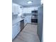 Newly renovated kitchen, featuring white cabinets, stainless steel appliances, and quartz countertops at 4292 Maple Ne St, St Petersburg, FL 33703