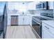 Modern kitchen with stainless steel appliances and white cabinets at 4292 Maple Ne St, St Petersburg, FL 33703