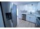Modern kitchen with stainless steel appliances and white cabinets at 4292 Maple Ne St, St Petersburg, FL 33703