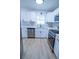 Updated kitchen with white cabinets, stainless steel appliances and quartz countertops at 4292 Maple Ne St, St Petersburg, FL 33703