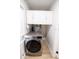 Laundry room with new LG washer and dryer, overhead cabinets and new flooring at 4292 Maple Ne St, St Petersburg, FL 33703