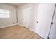 Clean laundry room featuring built-in shelving and updated flooring at 4292 Maple Ne St, St Petersburg, FL 33703