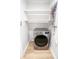 Laundry area with LG dryer, stacked shelving, and light wood flooring at 4292 Maple Ne St, St Petersburg, FL 33703