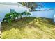 Landscaped side yard with lush greenery and white fence at 4292 Maple Ne St, St Petersburg, FL 33703