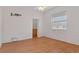 Bright bedroom with wood flooring and access to a walk-in closet at 4438 Crescent Rd, Spring Hill, FL 34606