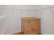 Walk-in closet with wire shelving and wooden storage cabinet at 4438 Crescent Rd, Spring Hill, FL 34606
