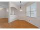 Bright dining room features wood-look floors and a view into the kitchen at 4438 Crescent Rd, Spring Hill, FL 34606