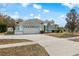 Front view of a single-story home with a white exterior and teal accents at 4438 Crescent Rd, Spring Hill, FL 34606